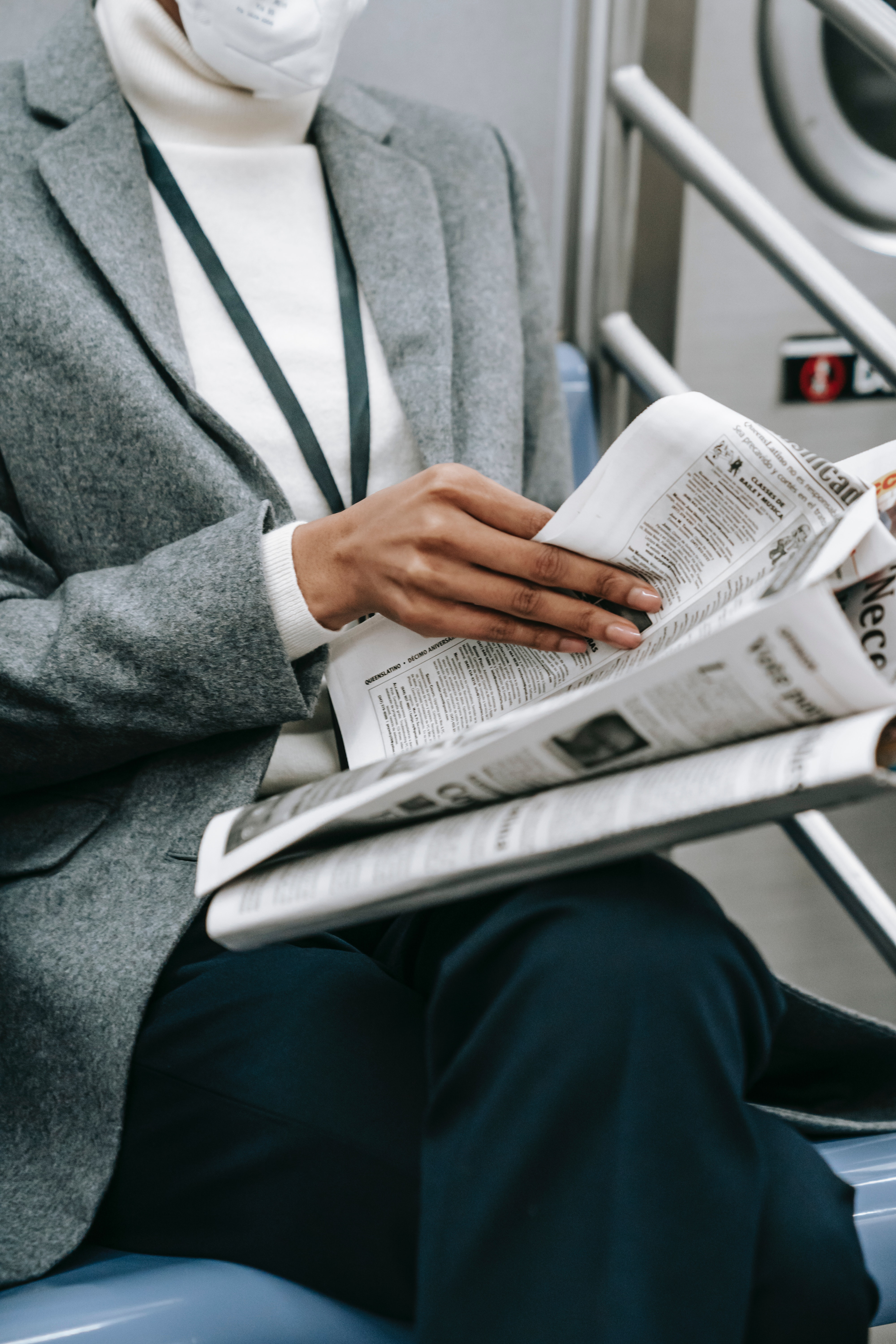 https://www.pexels.com/photo/unrecognizable-ethnic-businesswoman-reading-newspaper-in-train-6000100/